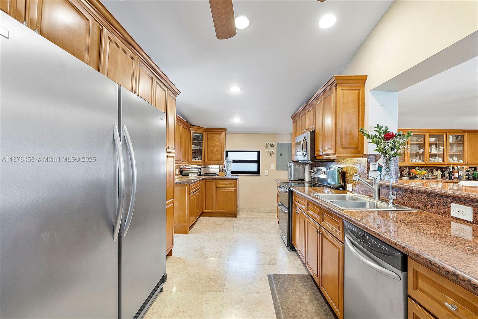 2531 Northeast 195th Street Aventura, FL 33180 - Photo 21 of 45 a kitchen with stainless steel appliances granite countertop a sink a stove and a refrigerator