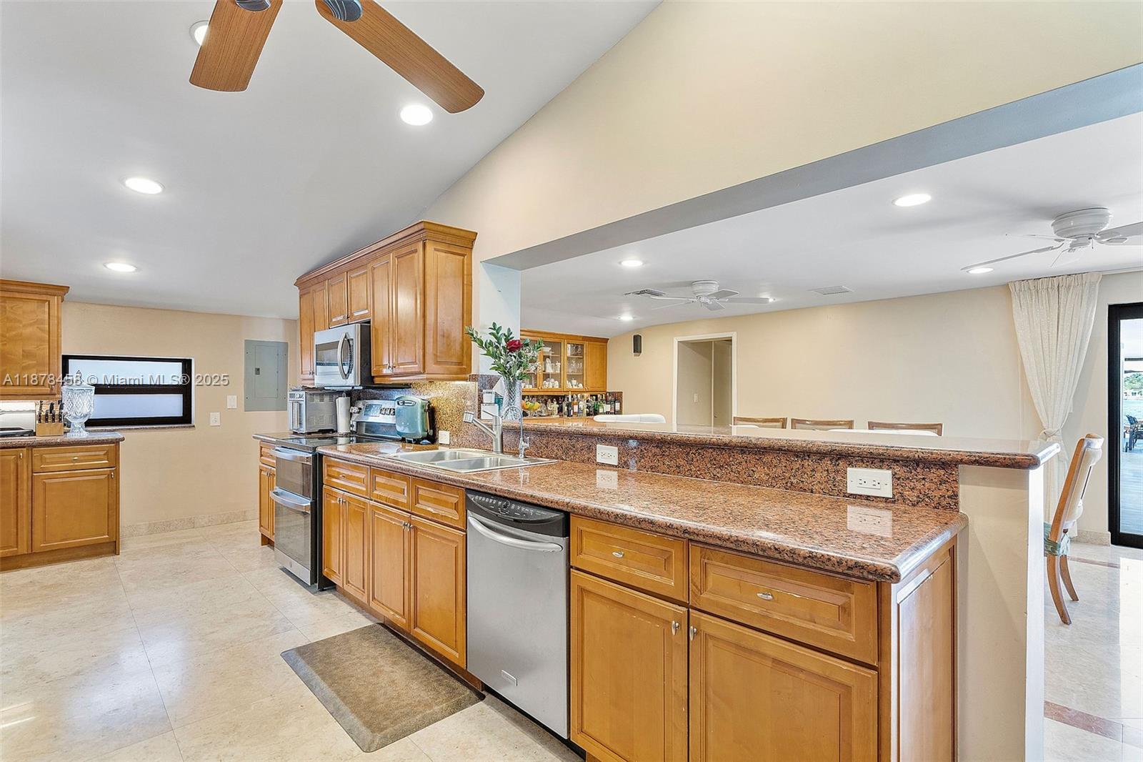 2531 Northeast 195th Street Aventura, FL 33180 - Photo 23 of 45 a kitchen with stainless steel appliances granite countertop a sink and cabinets