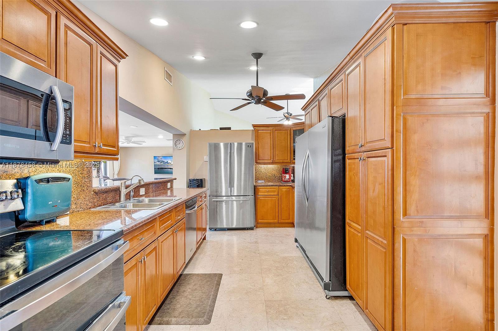 2531 Northeast 195th Street Aventura, FL 33180 - Photo 24 of 45 a kitchen with stainless steel appliances granite countertop a refrigerator and a sink