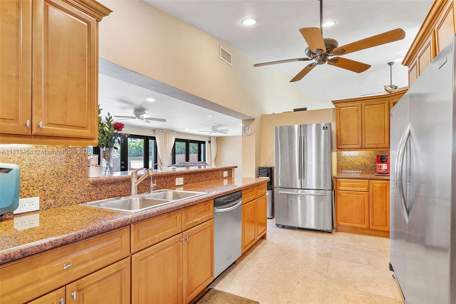 2531 Northeast 195th Street Aventura, FL 33180 - Photo 27 of 45 a kitchen with stainless steel appliances granite countertop a refrigerator a sink and white cabinets