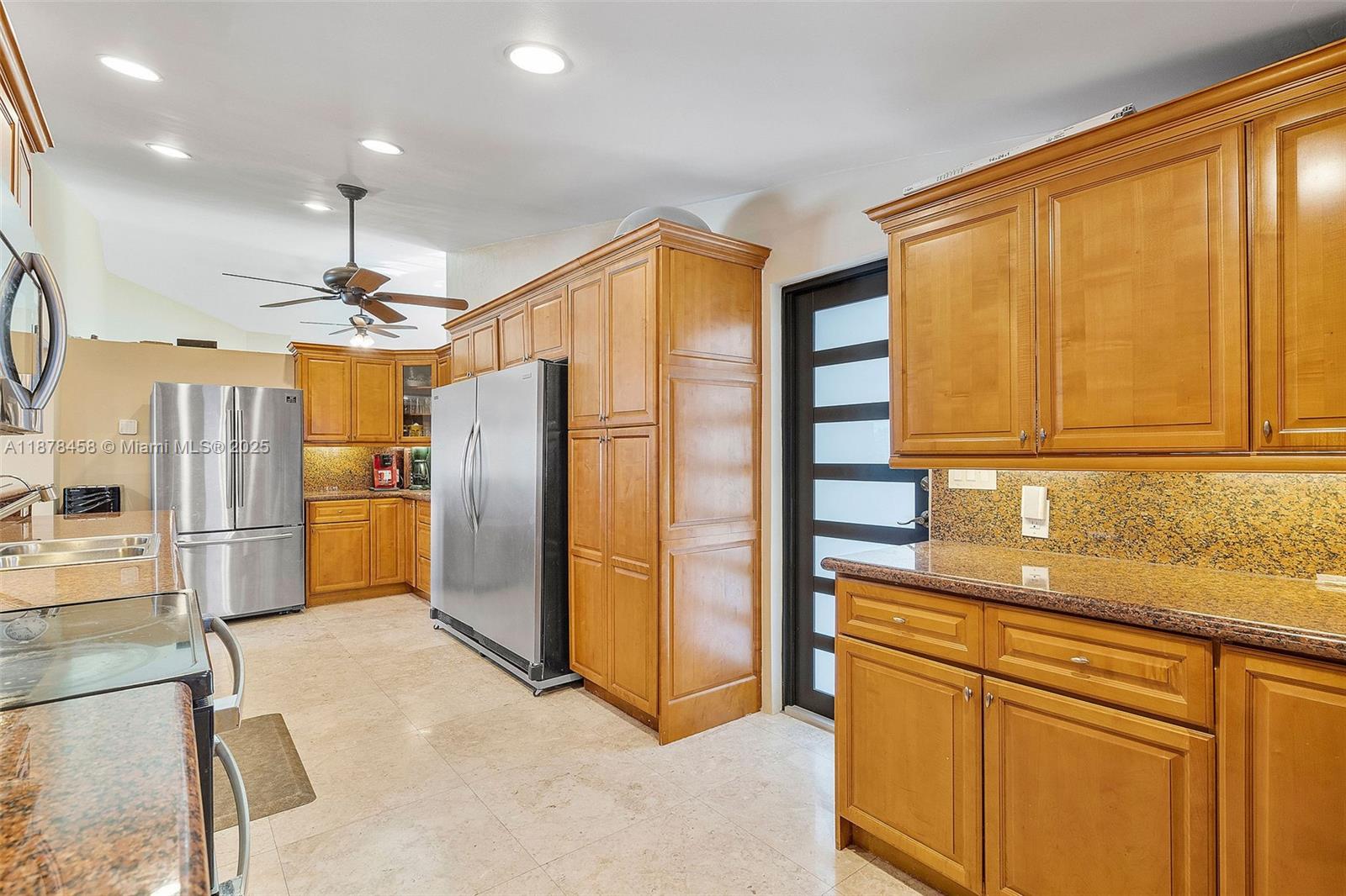 2531 Northeast 195th Street Aventura, FL 33180 - Photo 28 of 45 a kitchen with stainless steel appliances granite countertop a refrigerator and a sink