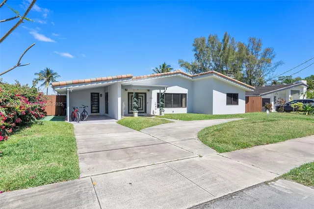 a front view of house with yard and green space