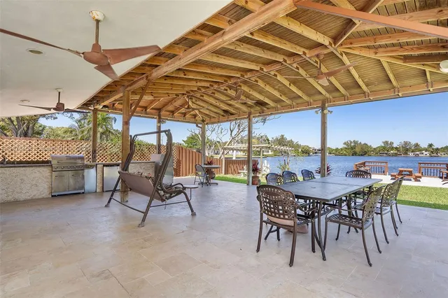 an aerial view of a house with a garden and lake view