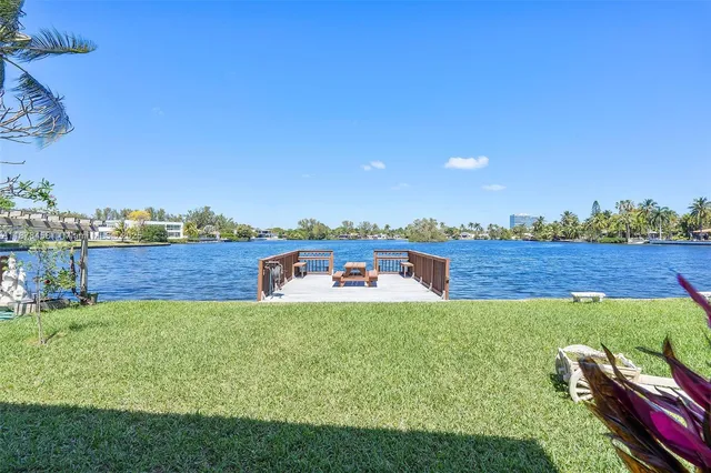 an aerial view of a house with outdoor space and lake view