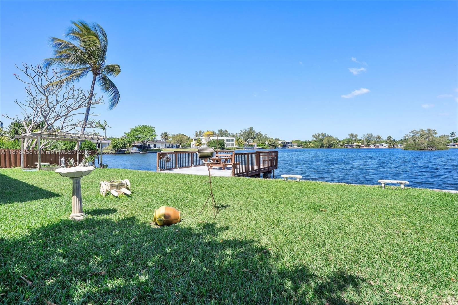 2531 Northeast 195th Street Aventura, FL 33180 - Photo 39 of 45 a backyard of a house with lots of green space