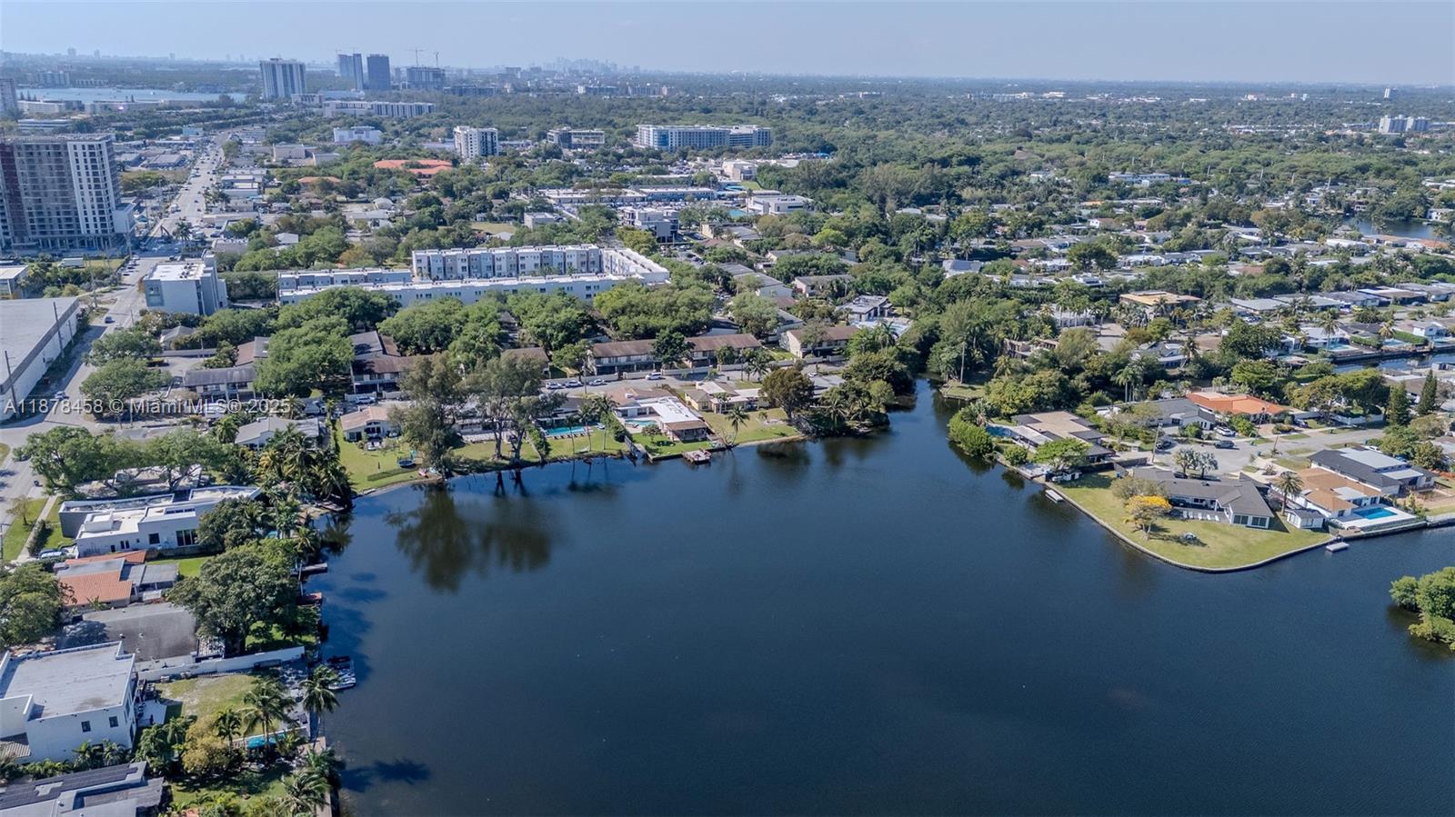 2531 Northeast 195th Street Aventura, FL 33180 - Photo 41 of 45 an aerial view of city and lake with trees all around