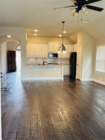 a view of a kitchen with a sink stainless steel appliances and cabinets