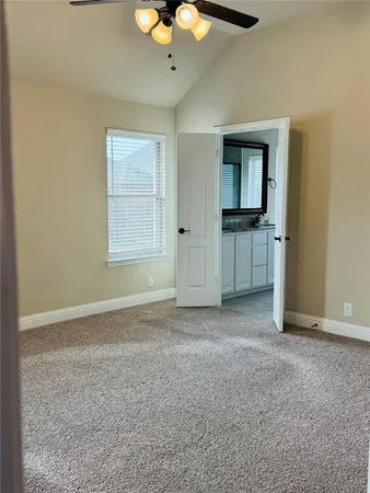 a view of a livingroom with a chandelier fan and a window