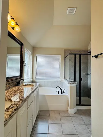 a spacious bathroom with a tub and a sink