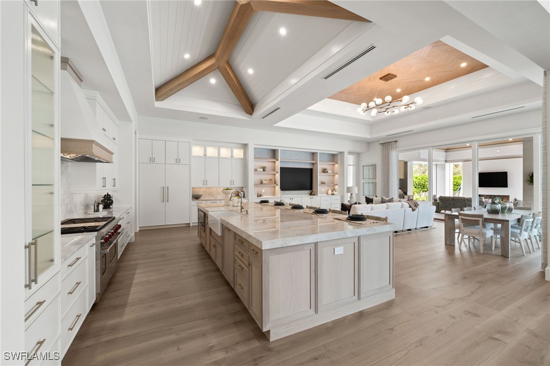 39 Cajeput Drive Naples, FL 34108 - Photo 11 of 50 a kitchen with lots of counter top space a sink appliances and cabinets