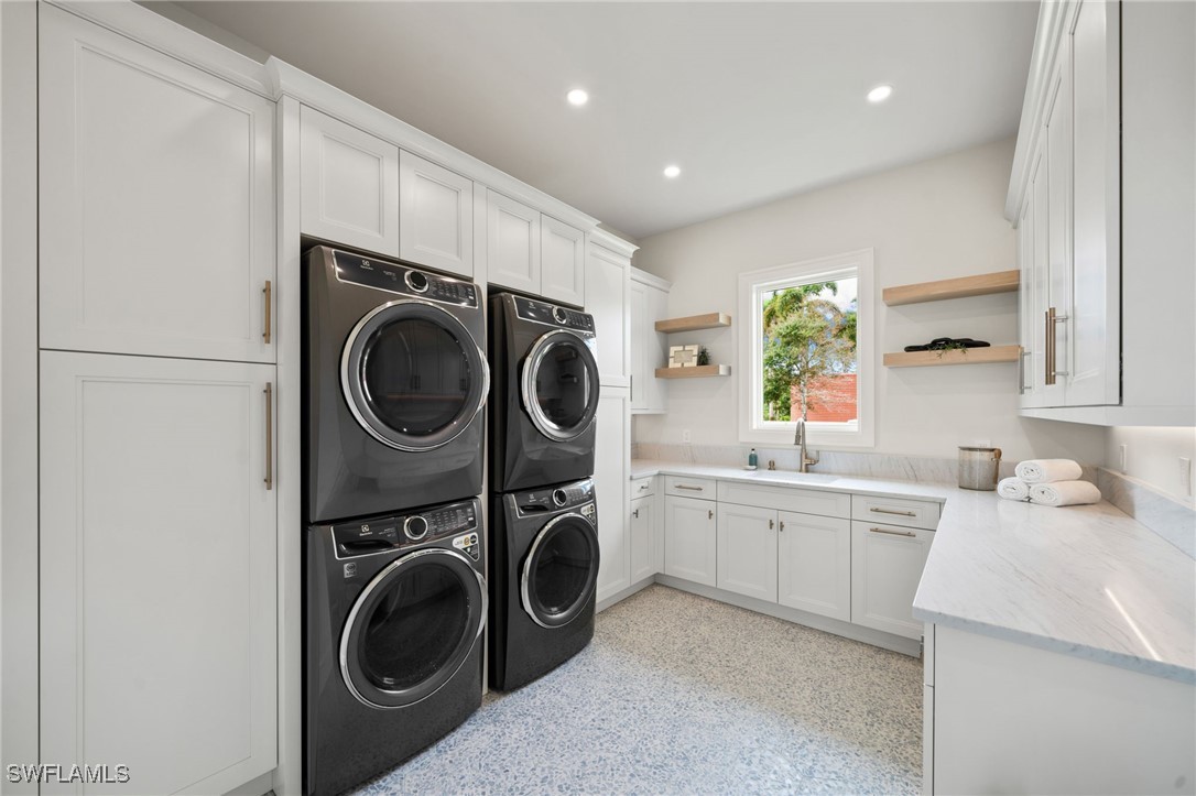 39 Cajeput Drive Naples, FL 34108 - Photo 14 of 50 a view of a kitchen with washer and dryer