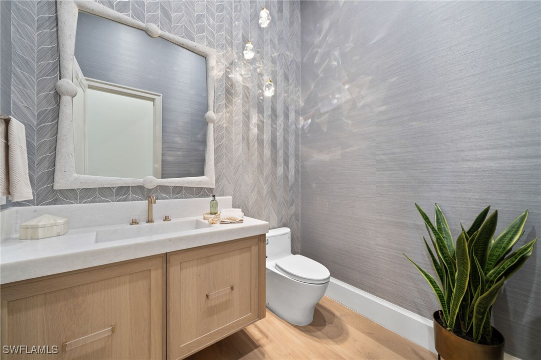 39 Cajeput Drive Naples, FL 34108 - Photo 15 of 50 a bathroom with a toilet a sink and mirror