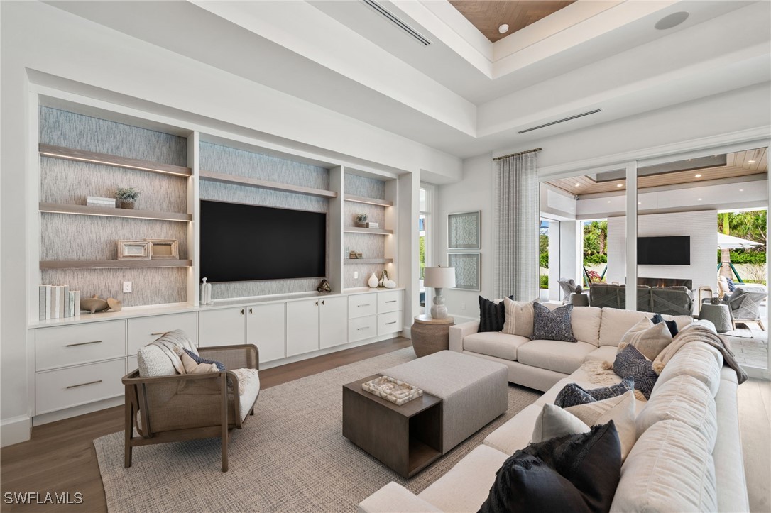 39 Cajeput Drive Naples, FL 34108 - Photo 16 of 50 a living room with furniture and a flat screen tv