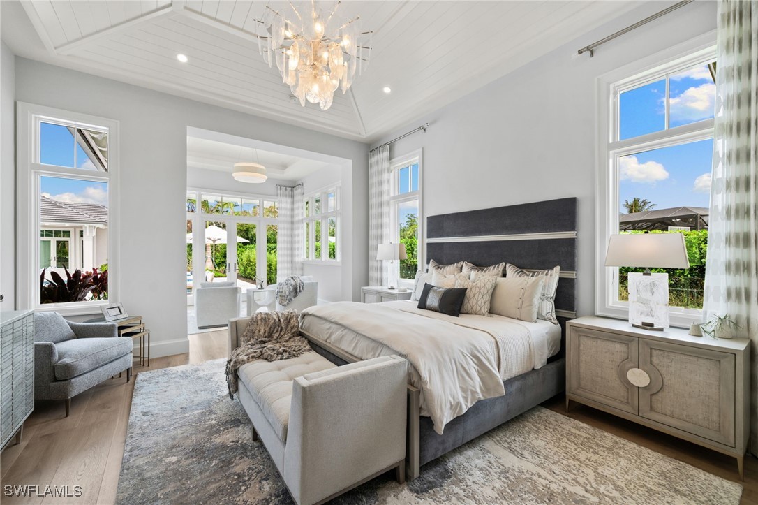 39 Cajeput Drive Naples, FL 34108 - Photo 19 of 50 a bedroom with a bed mirror and furniture