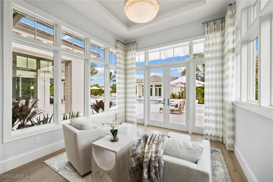 39 Cajeput Drive Naples, FL 34108 - Photo 21 of 50 a living room with furniture and a large window with outer view