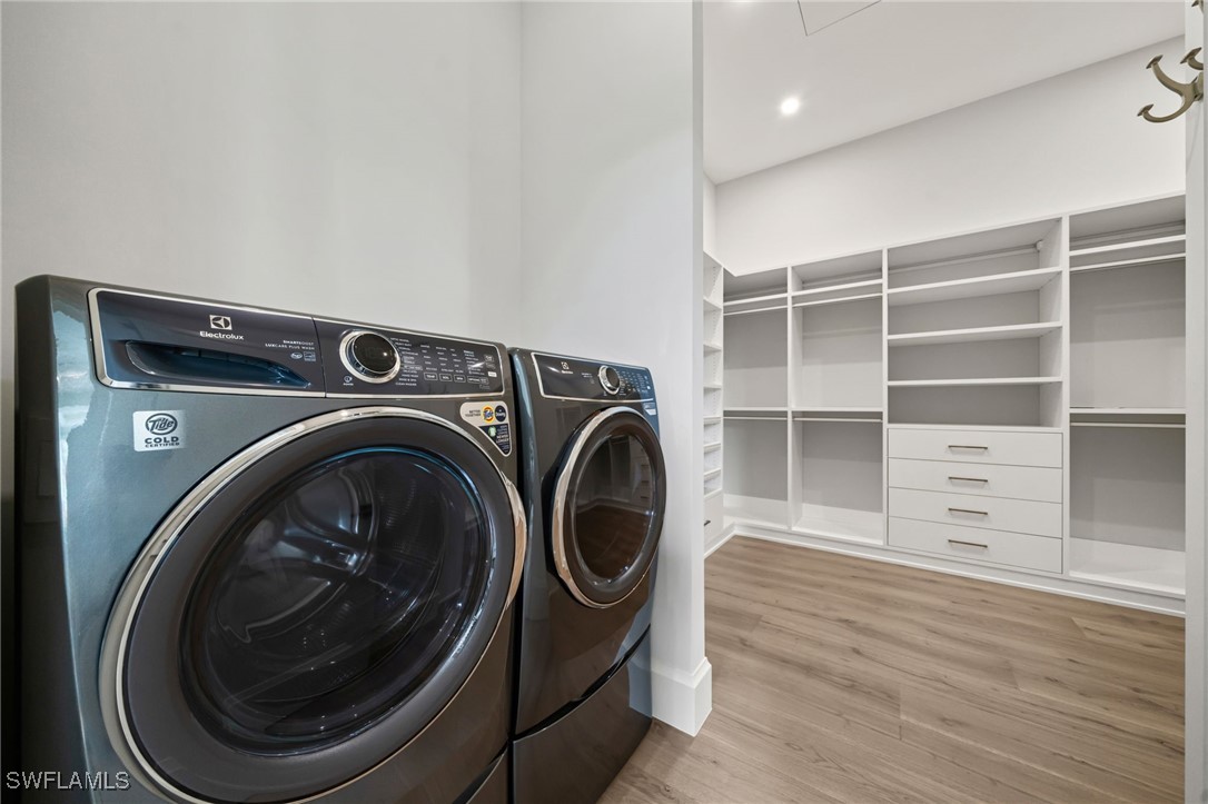 39 Cajeput Drive Naples, FL 34108 - Photo 25 of 50 a utility room with cabinets dryer and washer