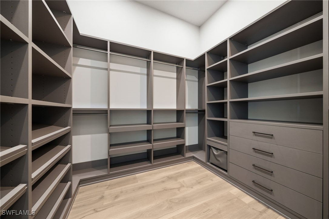 39 Cajeput Drive Naples, FL 34108 - Photo 26 of 50 a view of walk in closet with empty racks