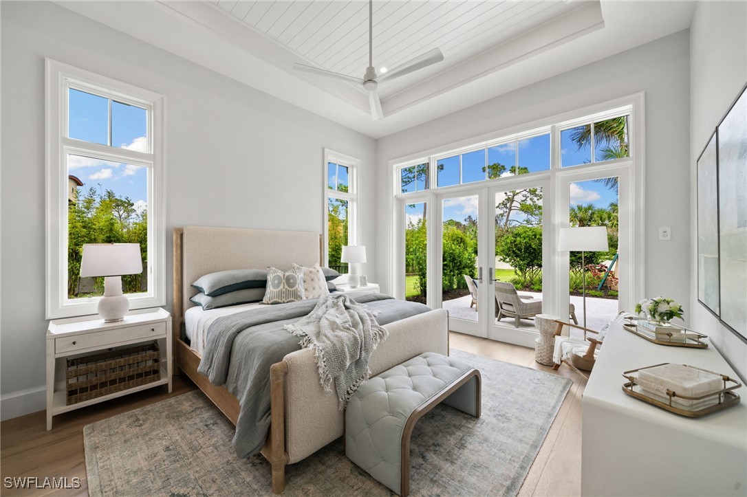 39 Cajeput Drive Naples, FL 34108 - Photo 29 of 50 a bedroom with furniture and a large window