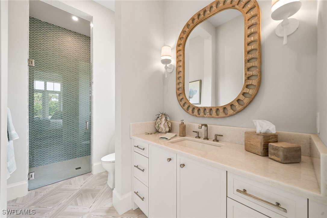 39 Cajeput Drive Naples, FL 34108 - Photo 30 of 50 a bathroom with a sink and a mirror