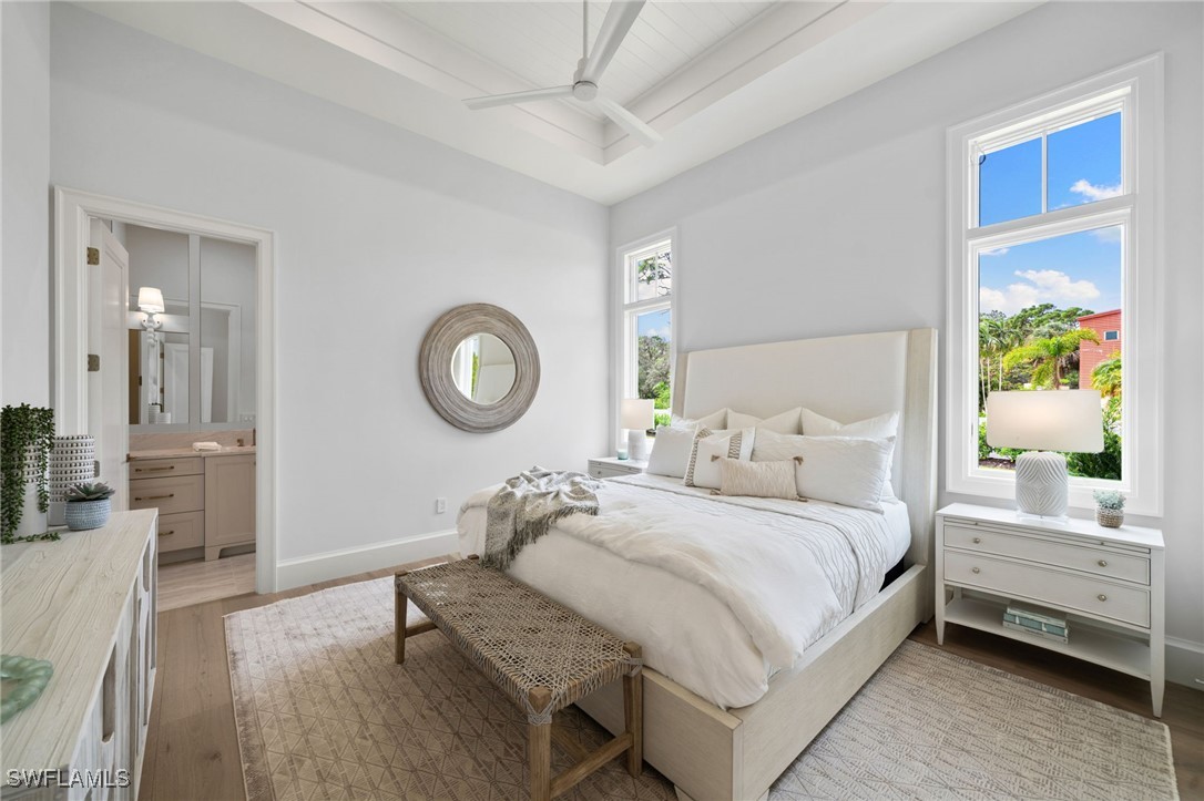 39 Cajeput Drive Naples, FL 34108 - Photo 33 of 50 a bedroom with a bed and a chandelier