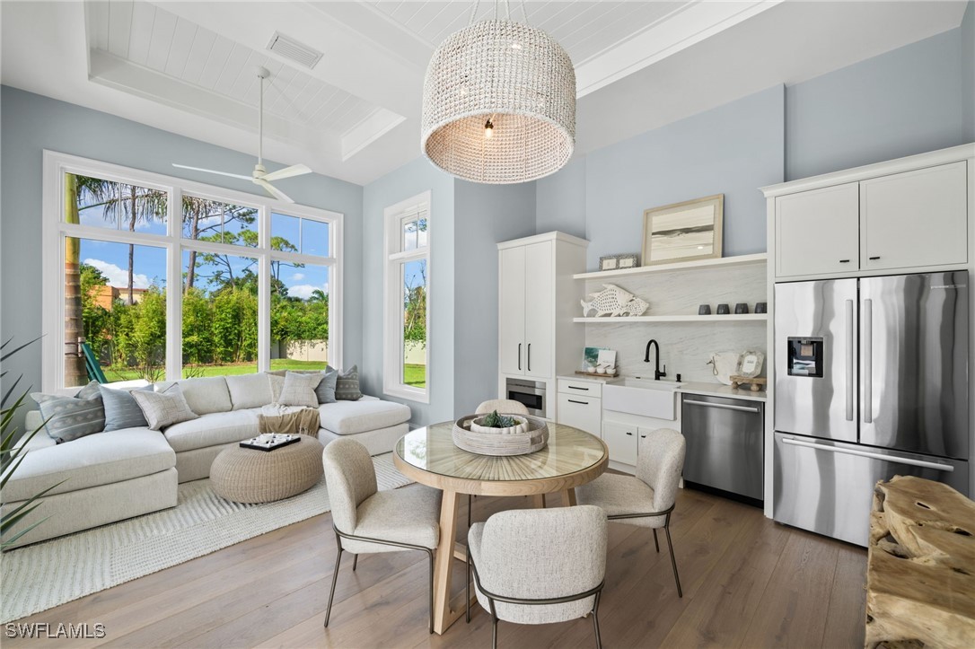 39 Cajeput Drive Naples, FL 34108 - Photo 35 of 50 a kitchen with stainless steel appliances a dining table and chairs