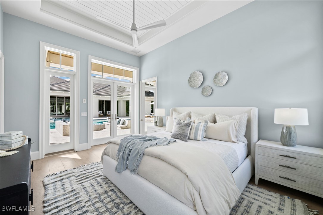 39 Cajeput Drive Naples, FL 34108 - Photo 37 of 50 a spacious bedroom with a large bed and a window