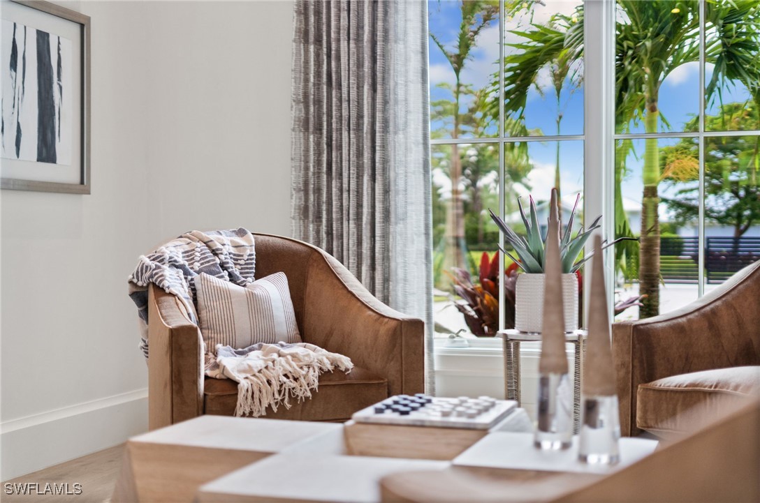 39 Cajeput Drive Naples, FL 34108 - Photo 39 of 50 a living room with furniture and flowers