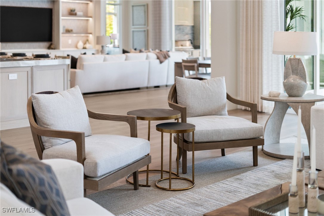 39 Cajeput Drive Naples, FL 34108 - Photo 41 of 50 a living room with furniture a flat screen tv and a table