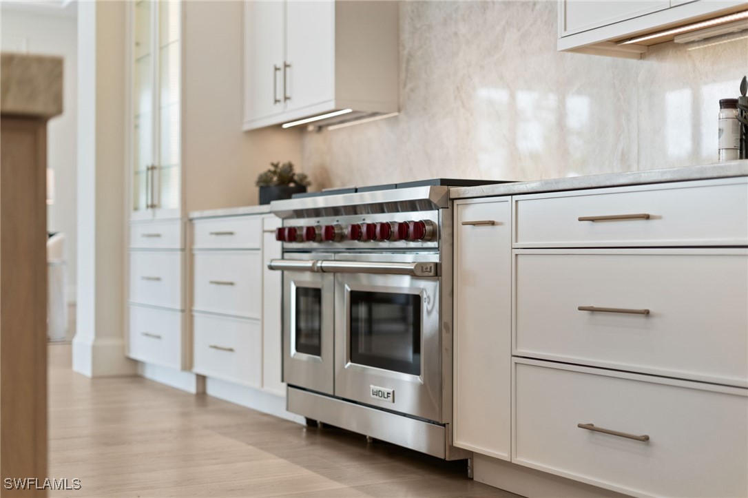 39 Cajeput Drive Naples, FL 34108 - Photo 43 of 50 a stove top oven sitting inside of a kitchen