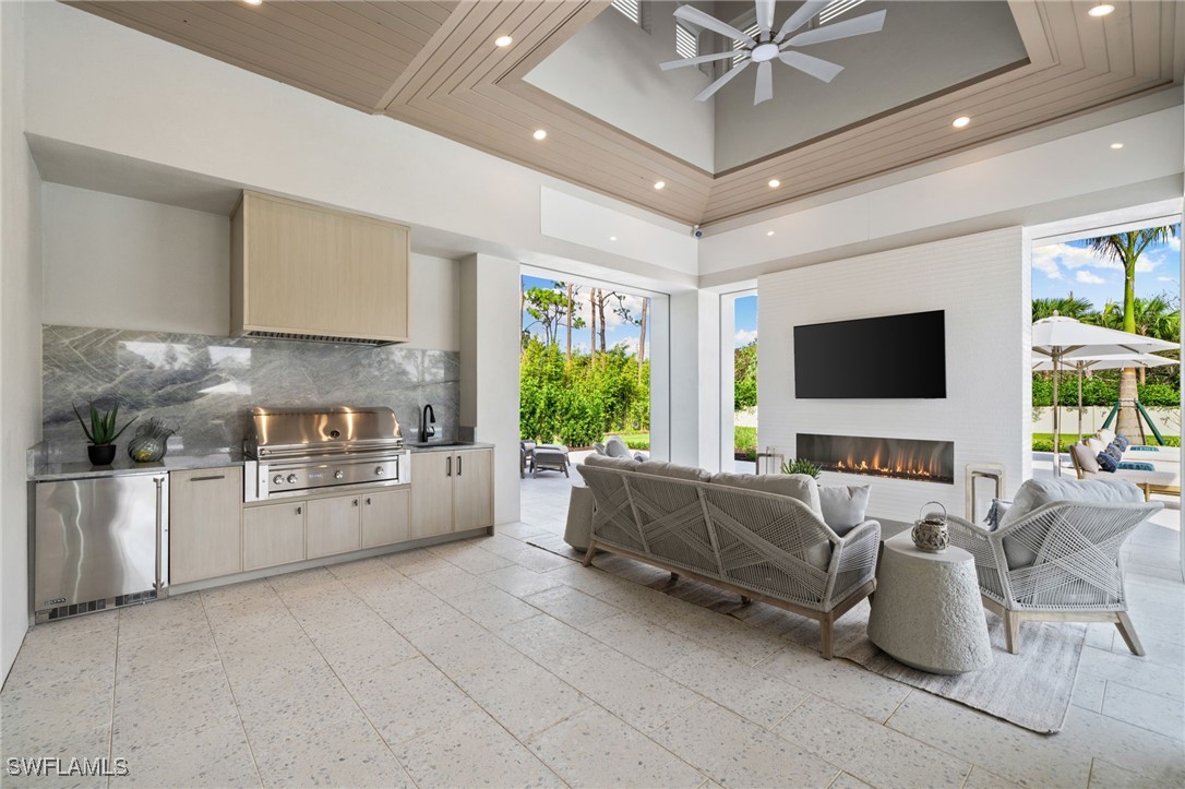 39 Cajeput Drive Naples, FL 34108 - Photo 46 of 50 a living room with furniture and a flat screen tv