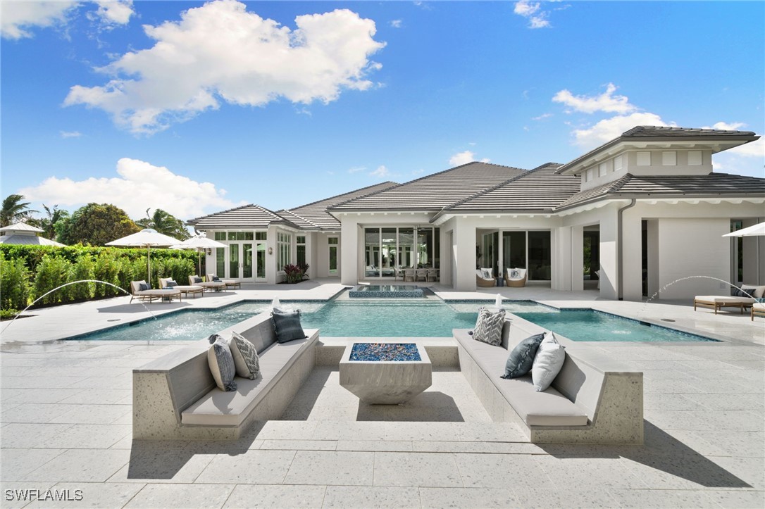 39 Cajeput Drive Naples, FL 34108 - Photo 47 of 50 a view of a house with swimming pool and sitting area