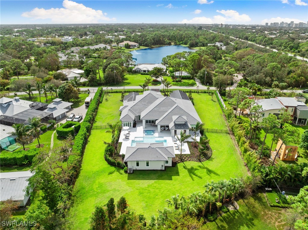 39 Cajeput Drive Naples, FL 34108 - Photo 49 of 50 an aerial view of a house with a garden and lake view