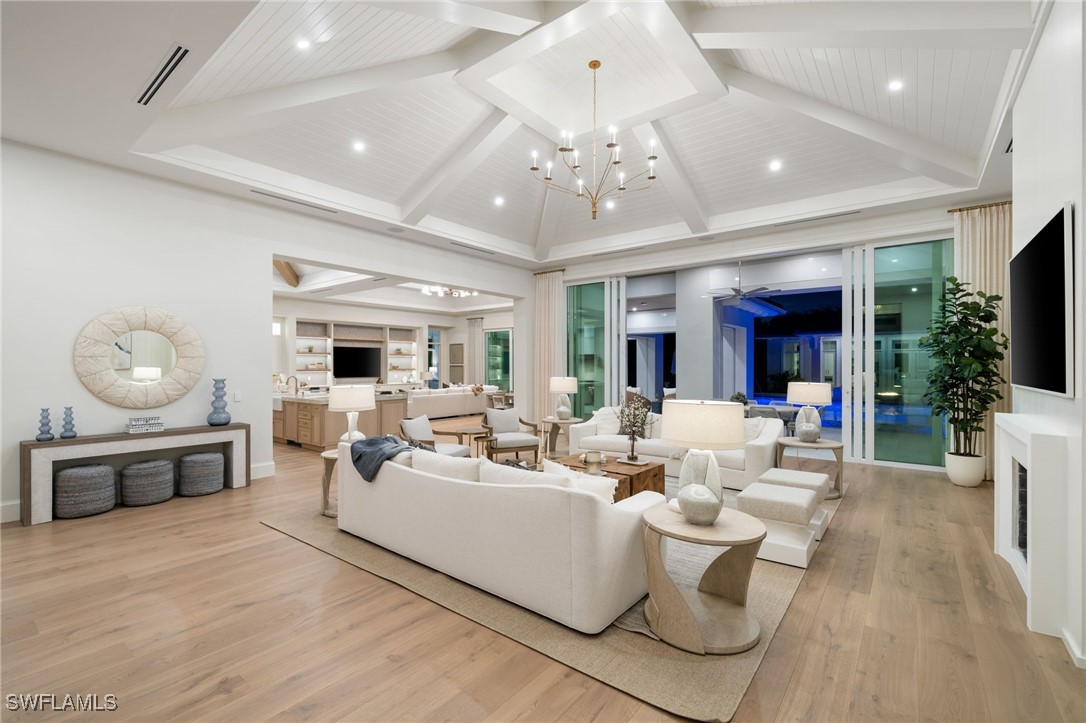 39 Cajeput Drive Naples, FL 34108 - Photo 7 of 50 a living room with furniture and a chandelier