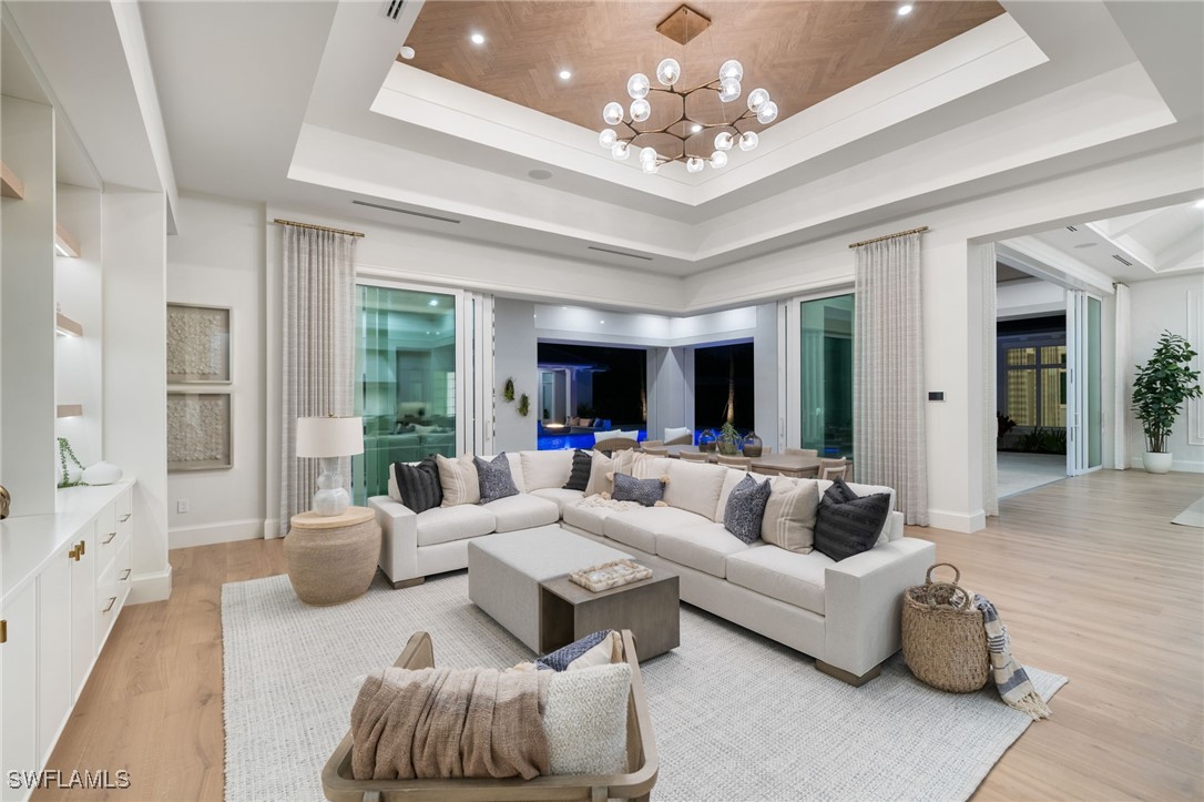 39 Cajeput Drive Naples, FL 34108 - Photo 8 of 50 a living room with furniture and a large window