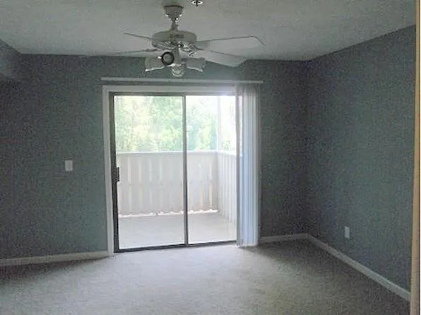 a backyard of a house with plants and outdoor seating