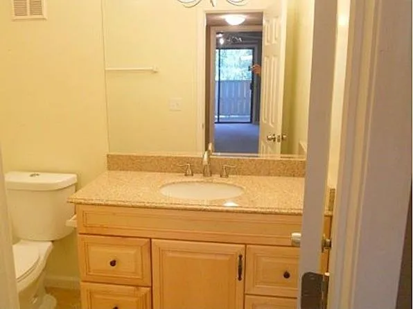 a view of a balcony with wooden floor and outdoor seating