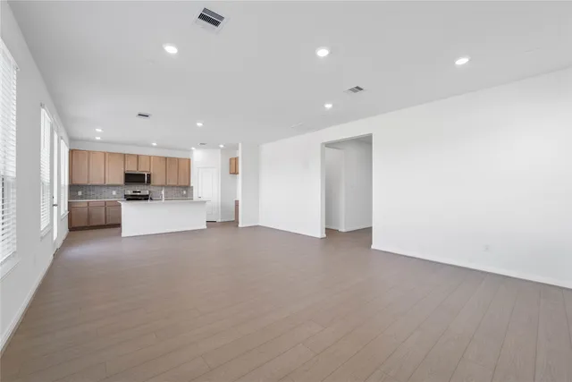 a view of a kitchen with a sink and a refrigerator