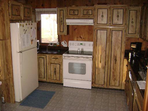 7872 Baylis Road Kinmundy, IL 62854 - Photo 3 of 16 a kitchen with stainless steel appliances granite countertop a refrigerator and a stove