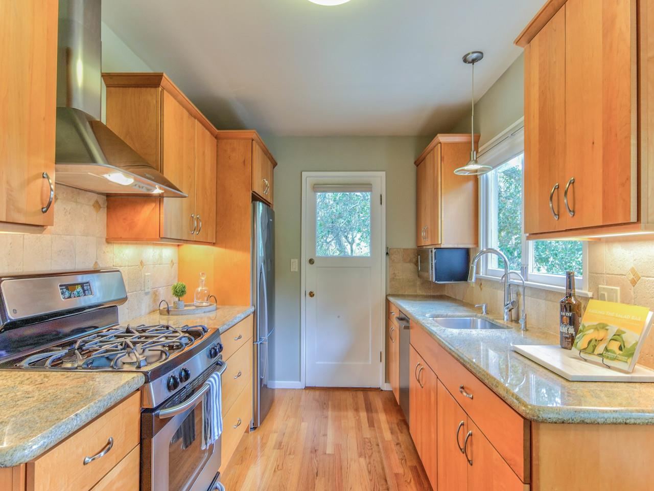 3 11th Avenue Carmel, CA 93923 - Photo 11 of 26 a kitchen with a sink a stove and refrigerator