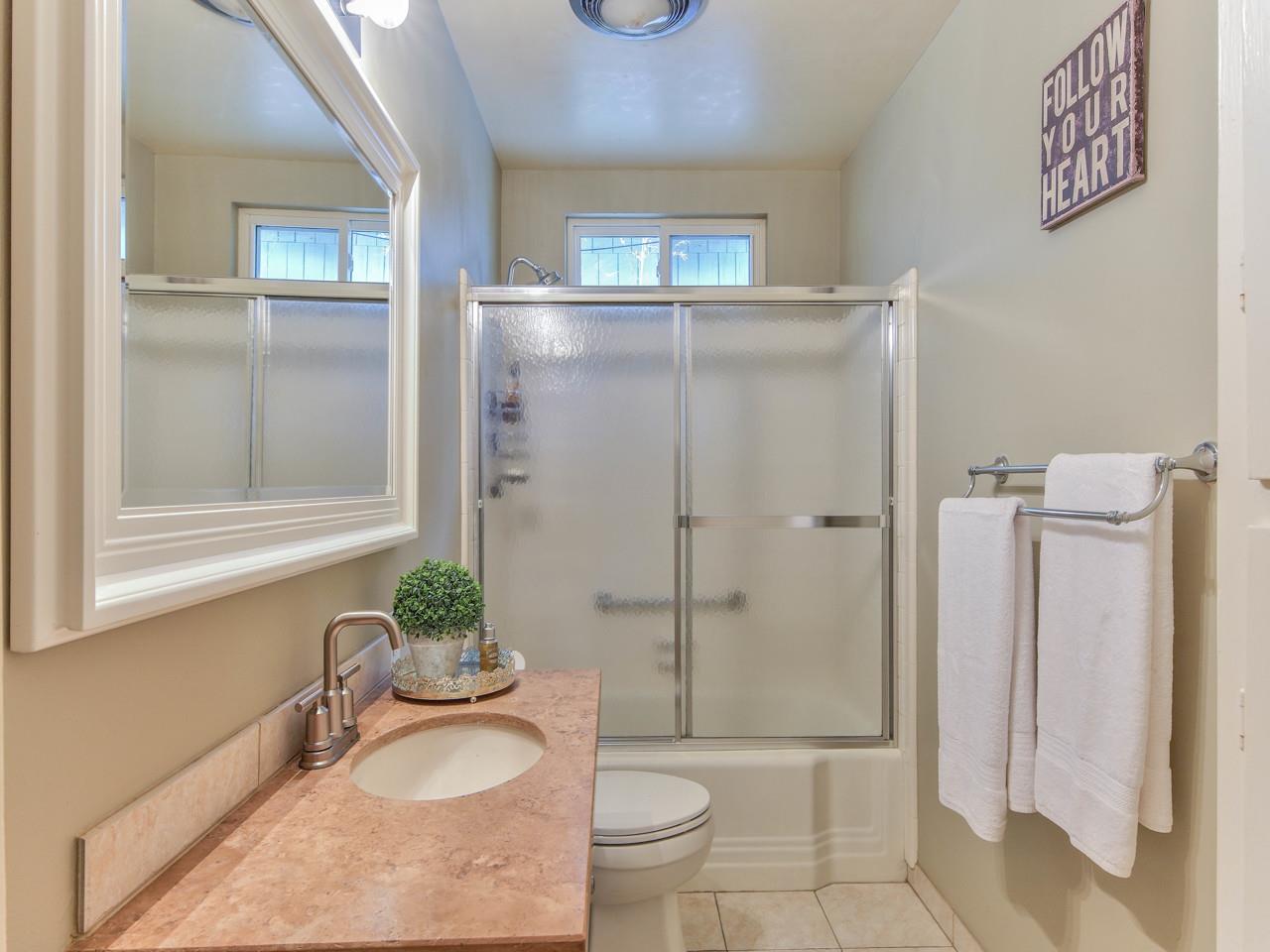 3 11th Avenue Carmel, CA 93923 - Photo 16 of 26 a bathroom with a granite countertop sink toilet and shower