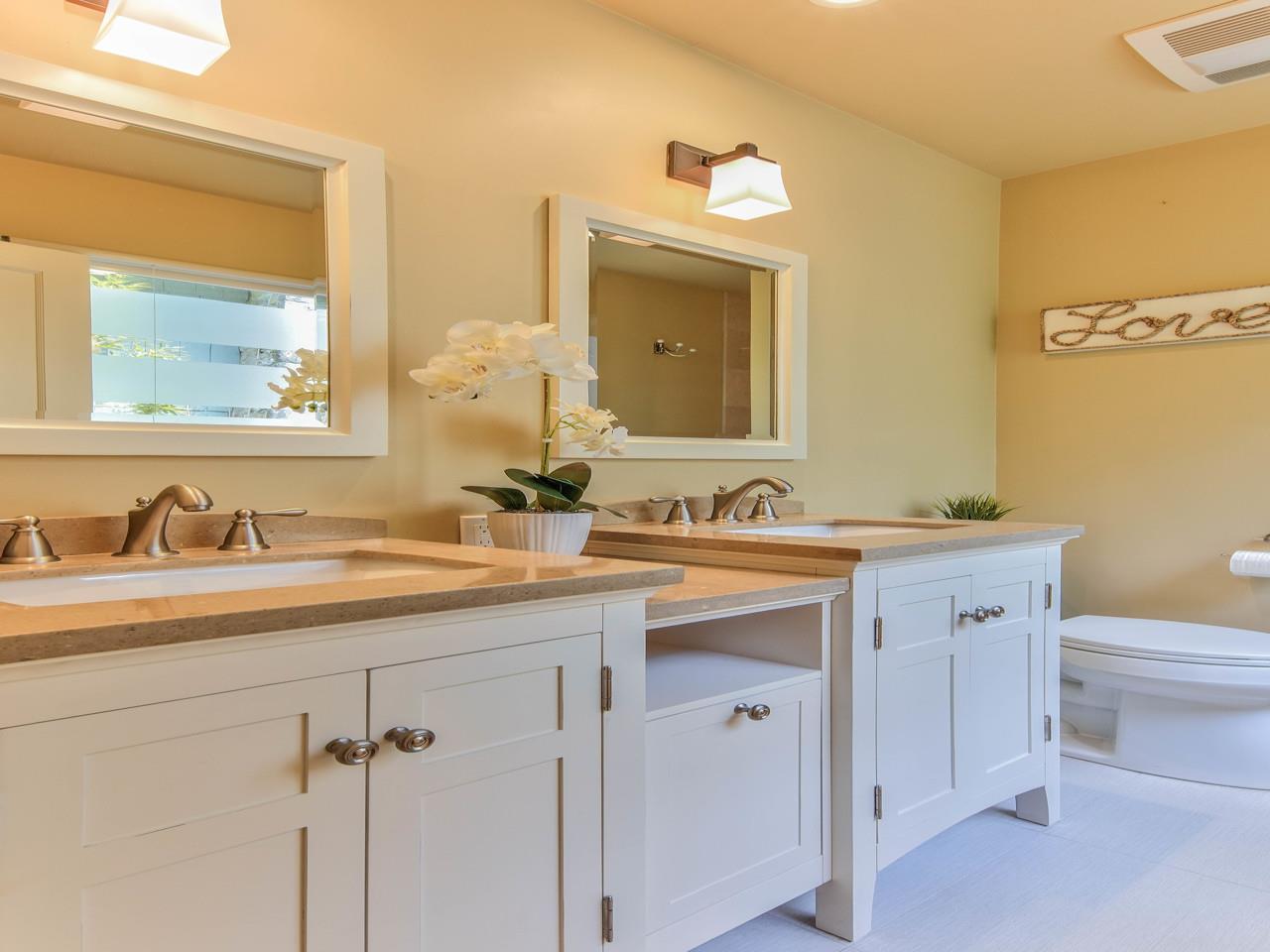 3 11th Avenue Carmel, CA 93923 - Photo 22 of 26 a bathroom with a granite countertop sink and a mirror