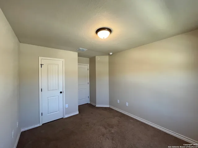 an empty room with closet area