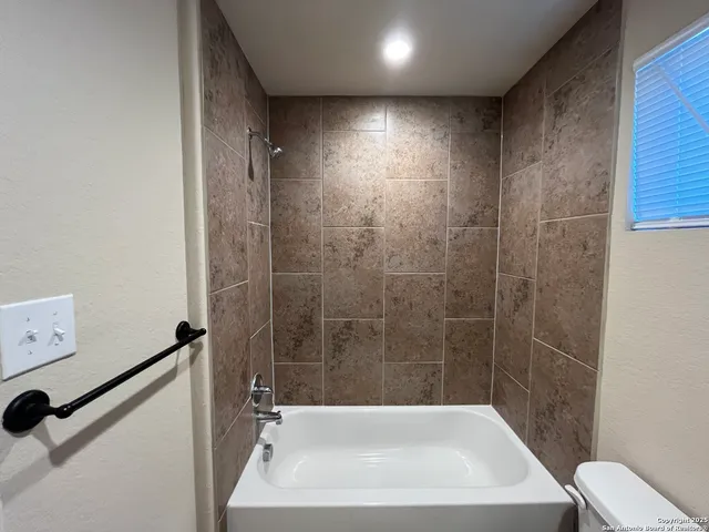 a bathroom with a tub and a shower