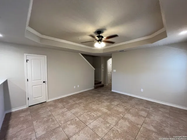 a view of an empty room with a ceiling fan