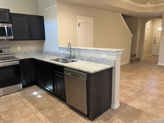 a kitchen with a sink and cabinets