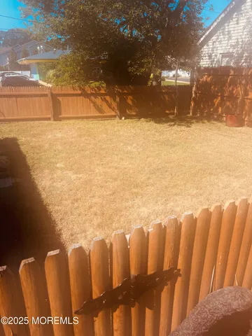 a view of yard with swimming pool and trees