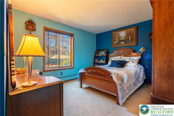 a bedroom with a bed and a mirror