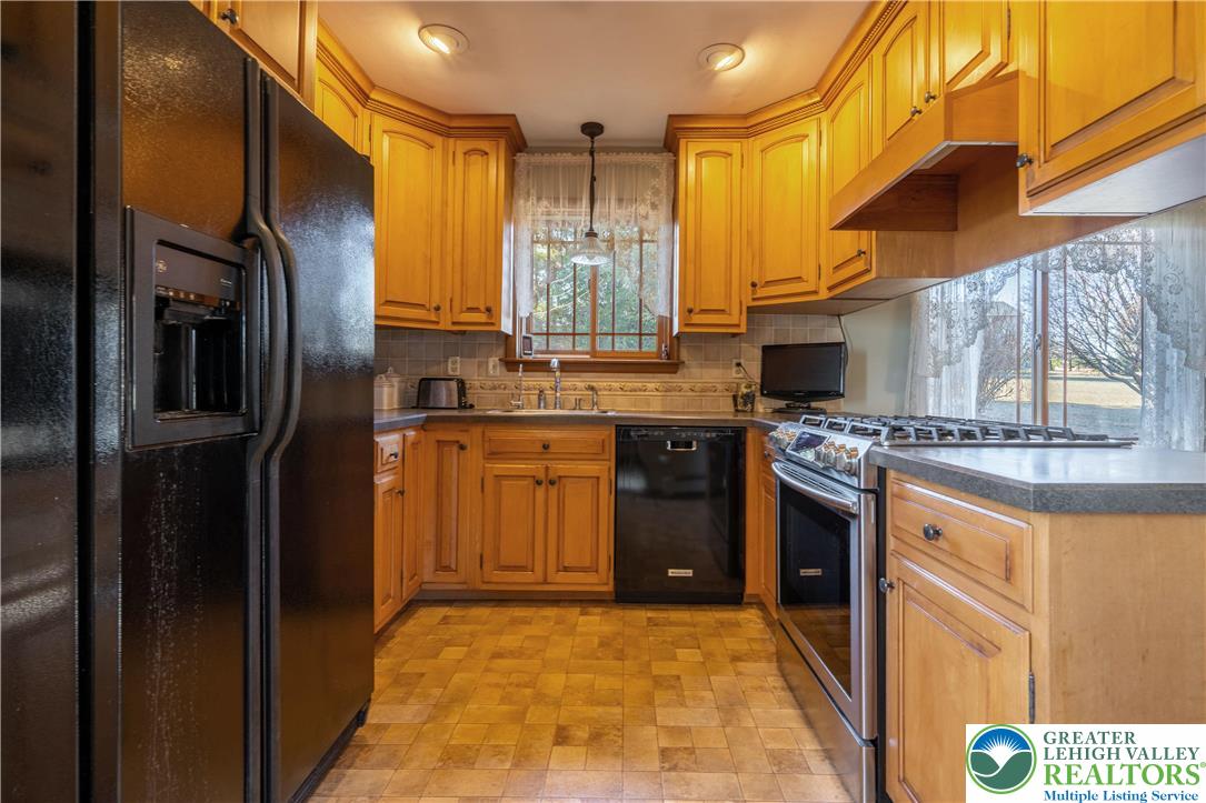 77 Uhlerstown Hill Road Erwinna, PA 18920 - Photo 3 of 47 a kitchen with stainless steel appliances granite countertop a stove a sink and a refrigerator