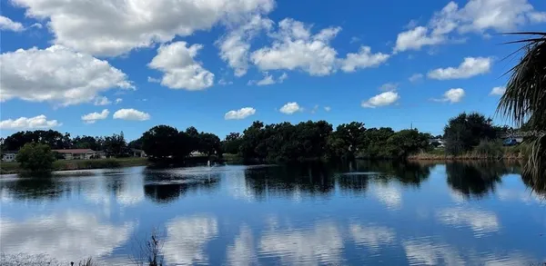a view of a lake with outdoor seating