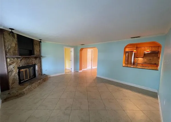 a view of a livingroom with an empty space and a fireplace